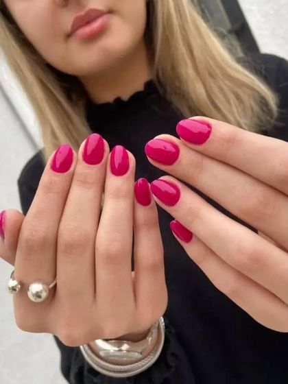 Another view of the vibrant magenta manicure, a perfect pop of color for any occasion.