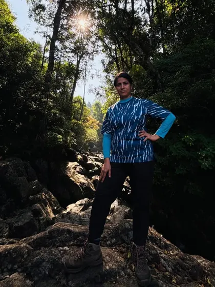 A trekker posing confidently on the rocky trail of Narasimha Parvatha.