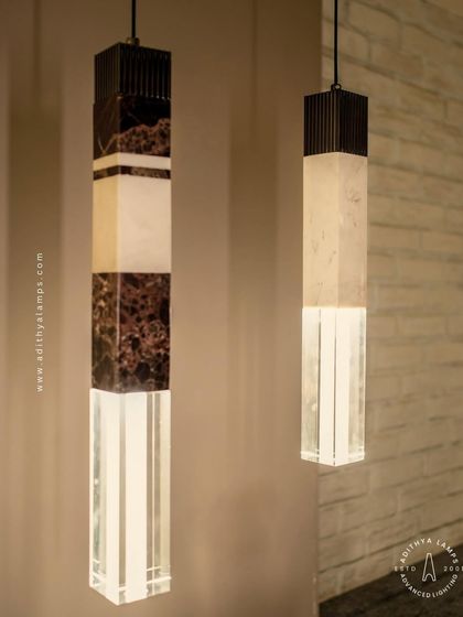 A collection of our pillar pendants, which combine sections of solid marble, fluted metal, and clear crystal. These substantial, high-quality fixtures can be hung individually or in clusters to create a dramatic effect in stairwells or entryways.