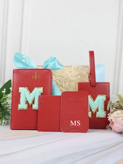 A perfect Rakhi gift for a brother who travels. This set includes a red passport cover, luggage tag, and card holders, all personalized with chenille patches.