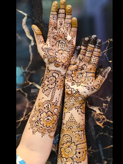 A lovely designer mehendi combining floral patterns on one hand with more geometric and traditional motifs on the other.