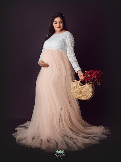 This two-toned gown with a white lace top and a flowing peach tulle skirt is a client favorite. It creates a soft, romantic, and elegant silhouette.