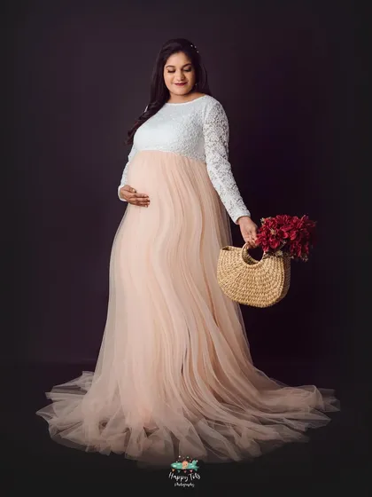 This two-toned gown with a white lace top and a flowing peach tulle skirt is a client favorite. It creates a soft, romantic, and elegant silhouette.