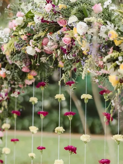 There's nothing more beautiful than a lush floral arch. For this Haldi ceremony, I designed a full, vibrant arch with hanging carnations that perfectly framed the couple and blended with the natural beauty of the garden.