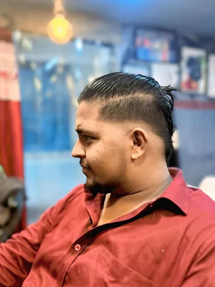 This is a modern take on a longer men's style, featuring an undercut with faded sides and longer hair on top, slicked back and tied.