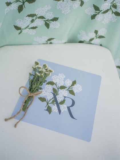 Personalized stationery with a floral motif, tied with a rustic twine bow, perfectly capturing the natural, elegant theme of the mountain wedding.