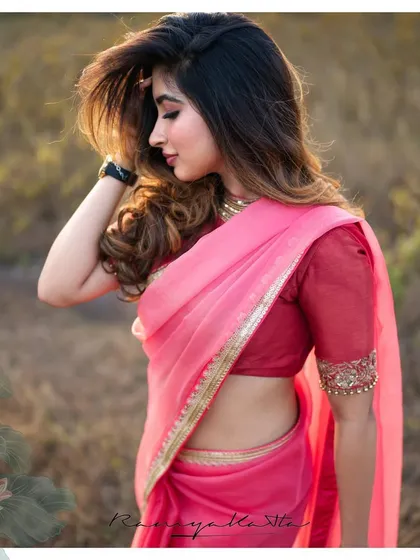 A profile shot of Saanya Iyer, showcasing the simple elegance of the organza saree and the delicate embroidery on the blouse sleeve.