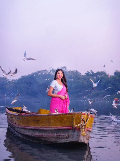 A serene portrait from the Yamuna Ghat series. The simple styling of the saree and minimal jewelry allows the natural beauty of the location and the subject to shine through, embodying an "old school" elegance.