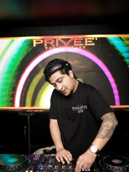 A close-up shot of me working the decks at Priveé. The colorful visuals in the background are a key part of the immersive experience we create for the audience every night.