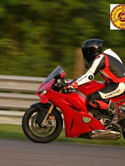 The unmistakable silhouette of a red Ducati Panigale at speed. We often have riders from the Ducati community join us for dedicated track sessions.