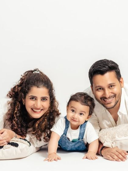 A happy family portrait taken in our clean, white studio. We love capturing the joy and connection between parents and their little ones.