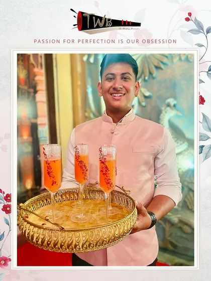 A tray of vibrant orange mocktails, beautifully presented in champagne flutes and ready to be served to guests.