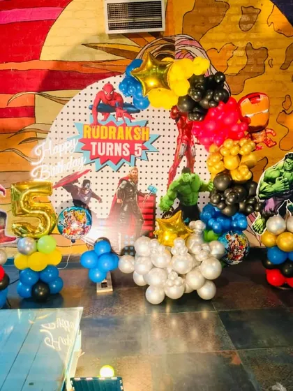 I bring popular superhero themes to life for action-packed kids' parties. This Avengers-themed 5th birthday includes character cutouts of Spider-Man and the Hulk, a comic-style backdrop, and balloon columns in the signature colors of the heroes.