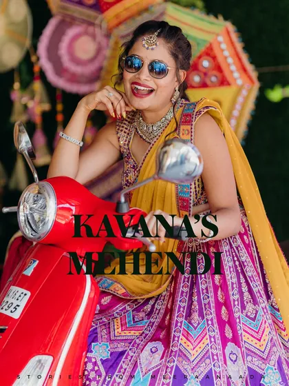 Your wedding is also about fun and personality. We love capturing the vibrant energy of pre-wedding ceremonies, like this Mehendi shot, where the bride's joyful spirit shines through in a colorful, lively setting.