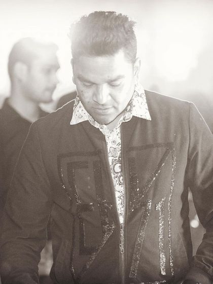 A sepia-toned shot that gives a timeless feel to the moment behind the decks. It's all about the craft of DJing.