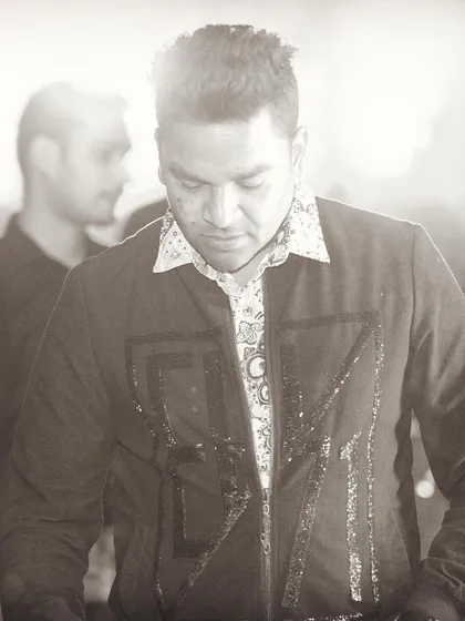 A sepia-toned shot that gives a timeless feel to the moment behind the decks. It's all about the craft of DJing.