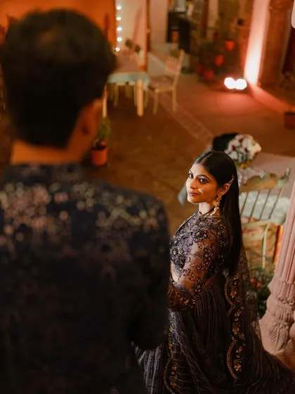 An over-the-shoulder shot of the bride looking back at the groom, creating a sense of story and connection.