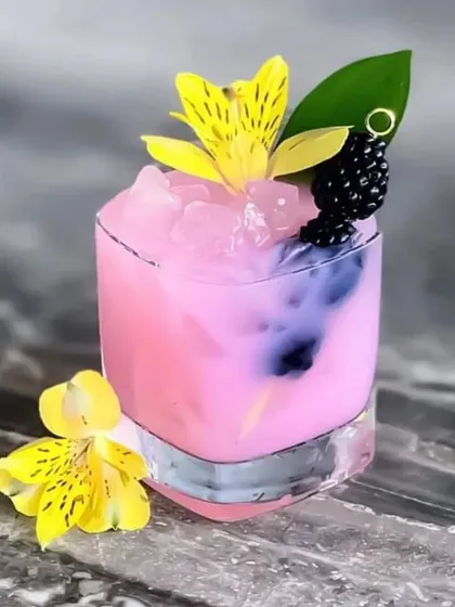Our bar service is all about crafting beautiful drinks that taste as good as they look. This vibrant pink mocktail, garnished with fresh flowers and berries, is a perfect example of how we add a pop of colour and elegance to any celebration.