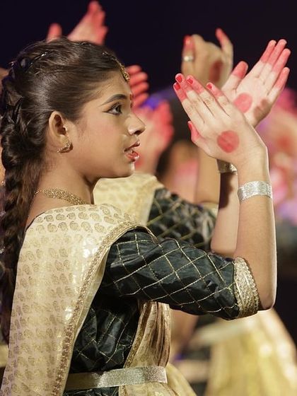 A young dancer from our Parampara, her hands adorned with 'alta', performing at Varshik Utsav 2024.