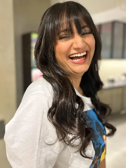 The pure joy of a great haircut. Her smile says everything about how confident and happy her new textured bangs and long layers make her feel.