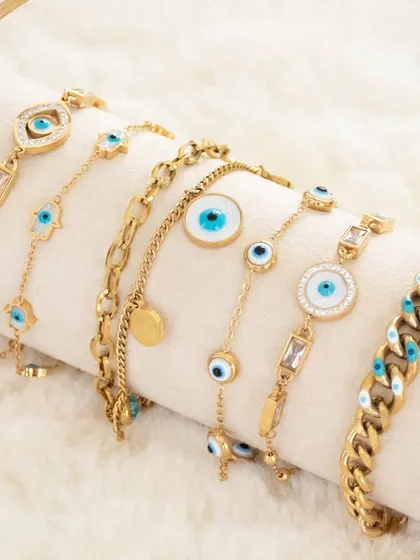 Charm your way through life with my most-loved evil eye bracelet collection. This image showcases a variety of styles, from curb chains to baguette-studded designs.