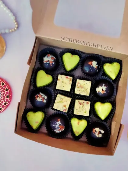 A closer look at my Indian fusion chocolate box. It features heart-shaped Paan Delight chocolates, square Rasmalai Pistachio pieces, and dark chocolate Almond Crackle bites.
