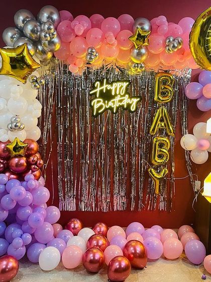 A "Twinkle Twinkle Little Star" theme for a 2nd birthday. This setup includes a shimmer curtain, moon and star balloons, "BABY" blocks, and a light-up number '2'.