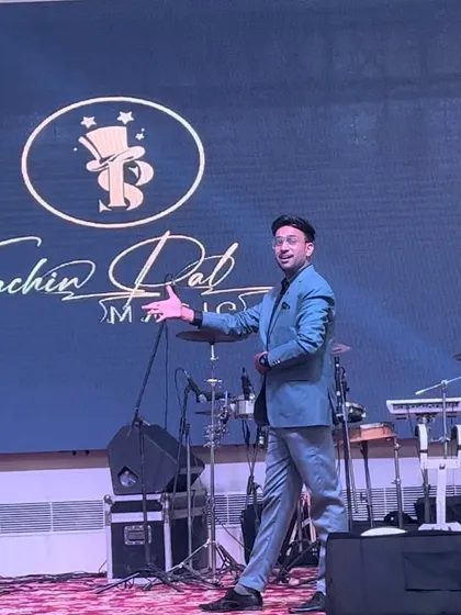 Welcoming the audience to the show. My open and engaging posture invites everyone to be a part of the magic.