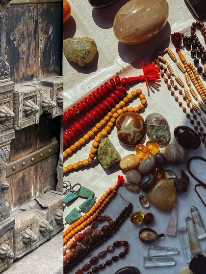 A collection of antique beads, crystals, and a heavily carved wooden door frame.