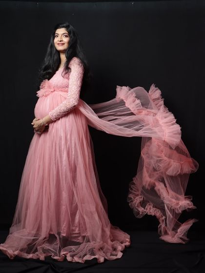 This shot shows the beautiful ruffled trail attachment for the pink lace-sleeve gown, adding extra drama and flair.