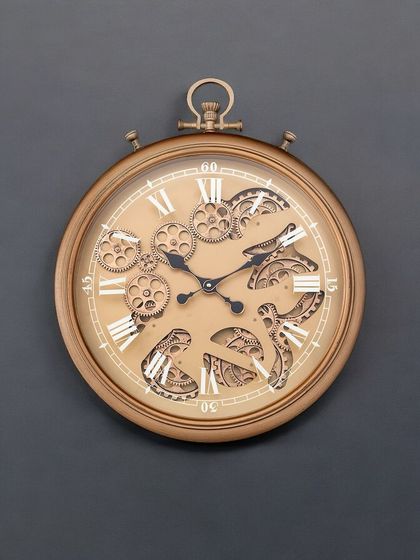 The same classic pocket-watch style wall clock, shown here in a warm antique gold finish. The moving gear mechanism adds a dynamic element to its vintage-inspired design.