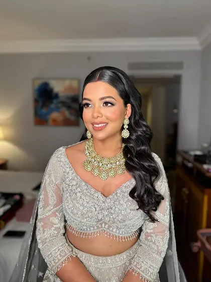 Shreya's happy smile completes her elegant reception look. The makeup is designed to be timeless and photograph beautifully.