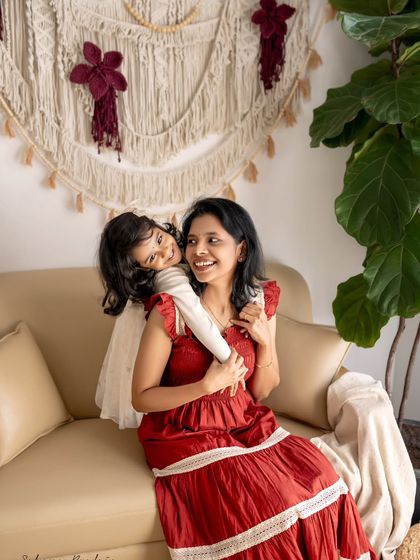 A daughter gives her mom a surprise hug from behind. This spontaneous show of affection is exactly the kind of authentic moment I love to capture during family sessions.