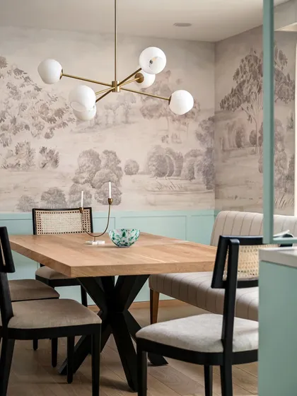 A custom mural is a powerful way to tell a story. In the Aqua Home's dining space, we commissioned a mural inspired by Bangalore's Gulmohar trees, paired with duck egg blue wainscoting to create a truly unique and personal dining experience.