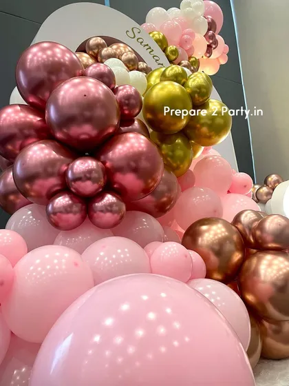A close-up of the balloon artistry, showing the mix of chrome, metallic, and pastel balloons used in this premium birthday decoration. The quality and density of the garland create a lush, high-end feel.