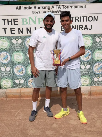 Arsh Kathuria with his coach and the U18 Boys Singles winner's trophy from the AITA Championship Series in Delhi.
