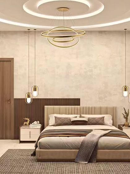 An elegant bedroom featuring a neutral color palette and sophisticated lighting. The design includes a stunning chandelier, pendant lights over the nightstands, and a beautiful coffered ceiling.