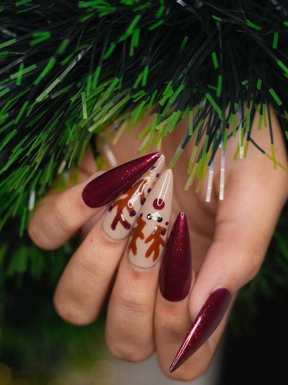 A side profile of the festive reindeer nail art. This view shows the smooth application and glossy finish of the polish, along with the cute, detailed face of the reindeer design.