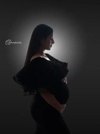 We use creative lighting to craft artistic and powerful images. This classic silhouette portrait, taken in our studio, beautifully highlights the stunning profile of the mother-to-be in a simple yet elegant black gown.