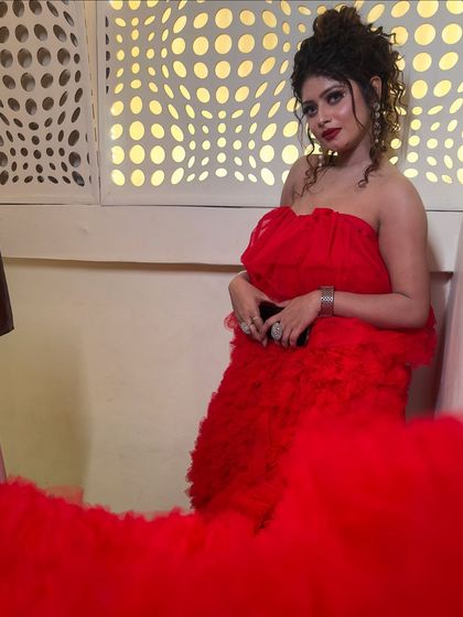 This fiery red ruffled gown is a statement piece. It's perfect for a glamorous photoshoot or a bold reception look.