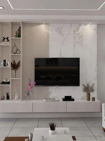 This bright and airy TV unit design mixes white marble, light wood textures, and open shelving. It's a perfect choice for a modern home that values a clean and minimalist aesthetic.