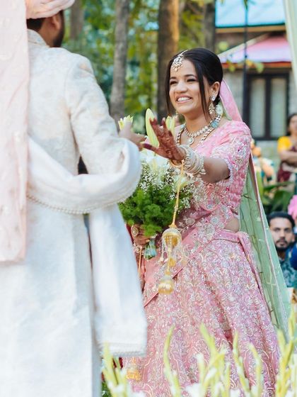 A repeat of image 362, a happy, candid moment of the bride during her varmala ceremony.
