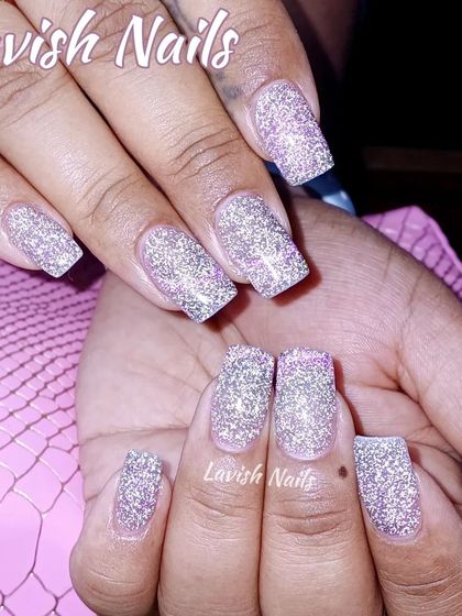 Full coverage silver holographic glitter on medium-length square nails for a high-impact, dazzling look.