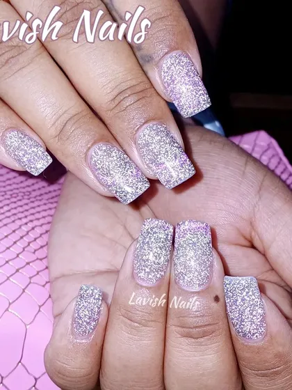 Full coverage silver holographic glitter on medium-length square nails for a high-impact, dazzling look.