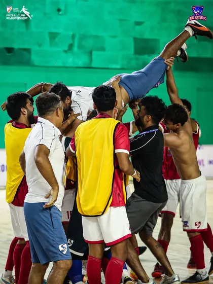 The team tossing our coach in celebration after the final whistle.