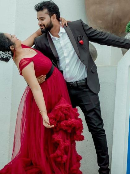 A romantic dance pose for a pre-wedding shoot. The ruffled red gown adds a touch of passion and movement to this beautiful photo.