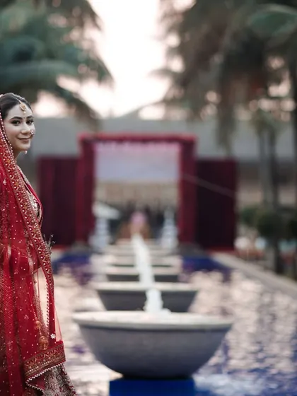 A stunning portrait of the bride just before her entrance. The poolside location at Della Resorts provides a beautiful, serene backdrop.