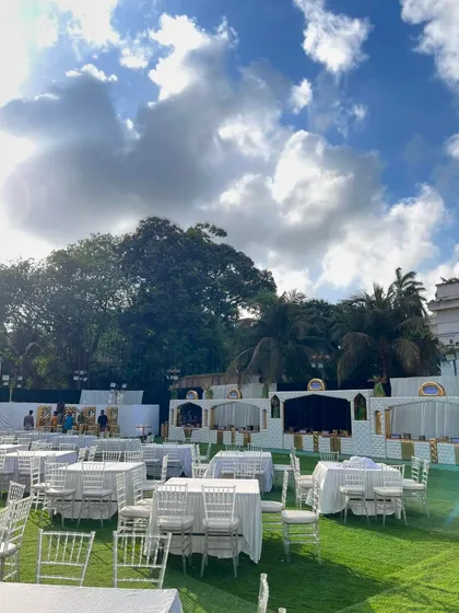 The expansive lawn set up for a large wedding, with my team ensuring every detail is perfect before guests arrive.