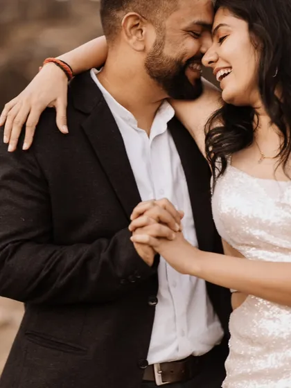 A joyful and candid moment of the couple dancing and laughing together. This image perfectly captures their fun-loving and happy connection.