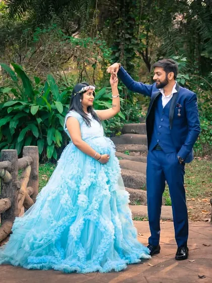 A dance on the bridge. This photo captures a moment of joy and romance, with the mom-to-be's light blue gown swirling around her.